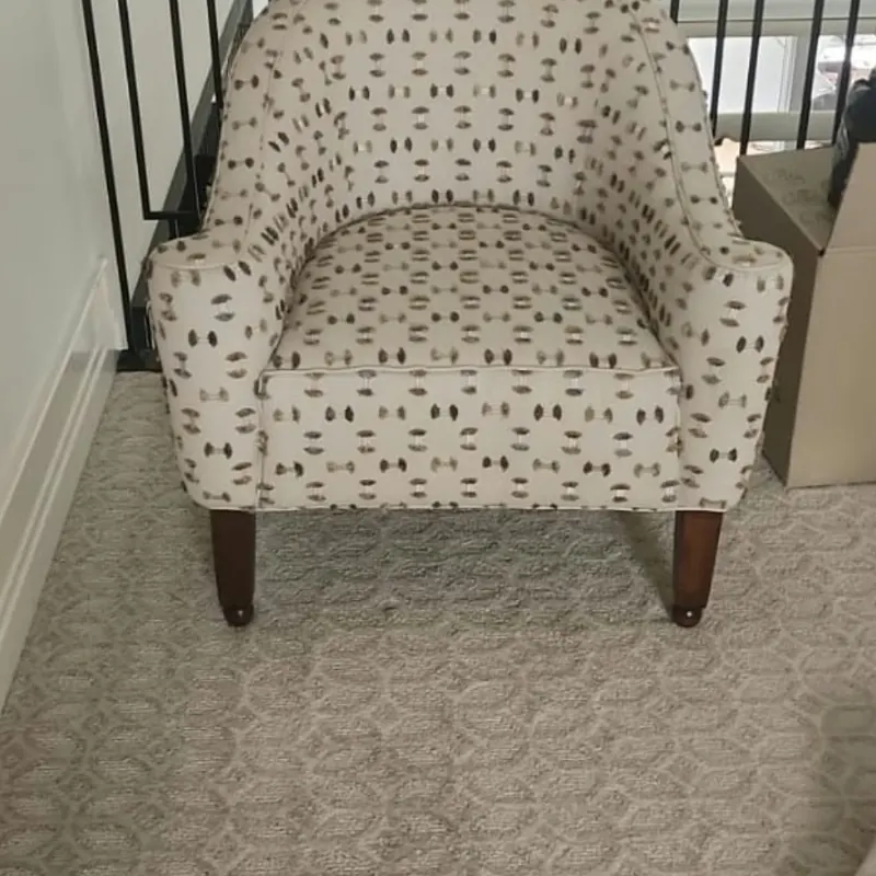 Armchair after reupholstery in a modern patterned fabric