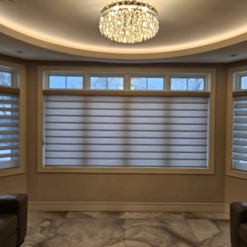 Banded shades on a curved bay by Elegant Window Fashion
