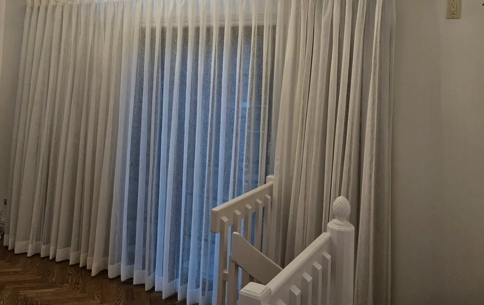 Pinch-pleat sheers along the stairs by Elegant Window Fashion