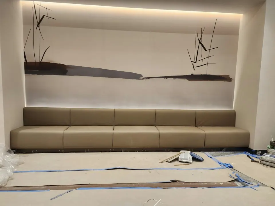 Banquette under a lit art wall by Elegant Window Fashion