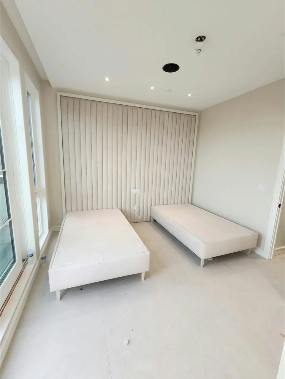 Channel-tufted wall and twin beds by Elegant Window Fashion
