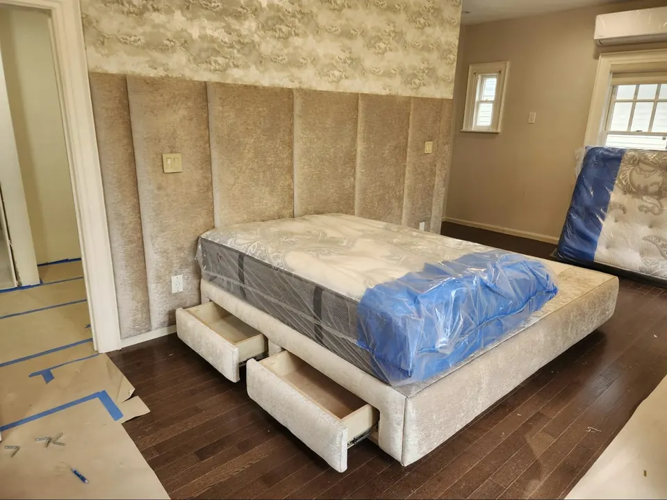 Upholstered storage bed and panel wall by Elegant Window Fashion